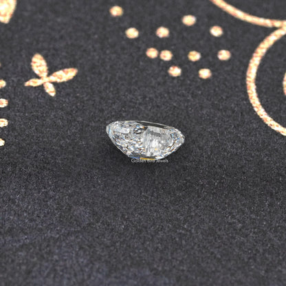 Duck-cut lab-grown diamond with pointed ends, stepped facets, close-up