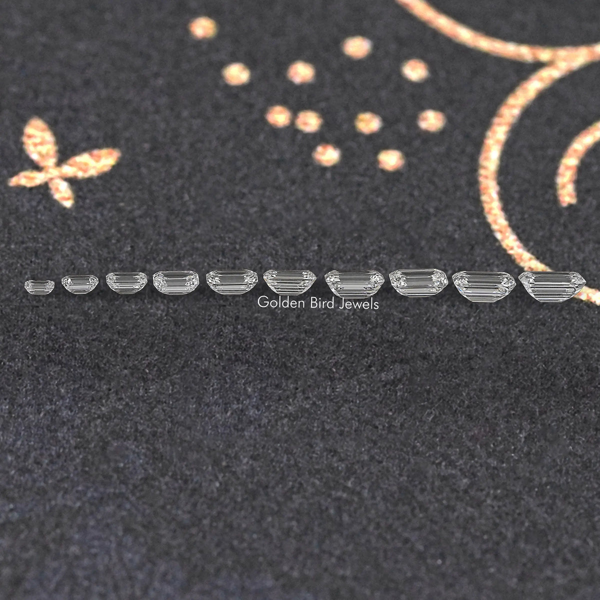 Row of loose emerald-cut lab-grown diamonds, side profile showing stepped facets
