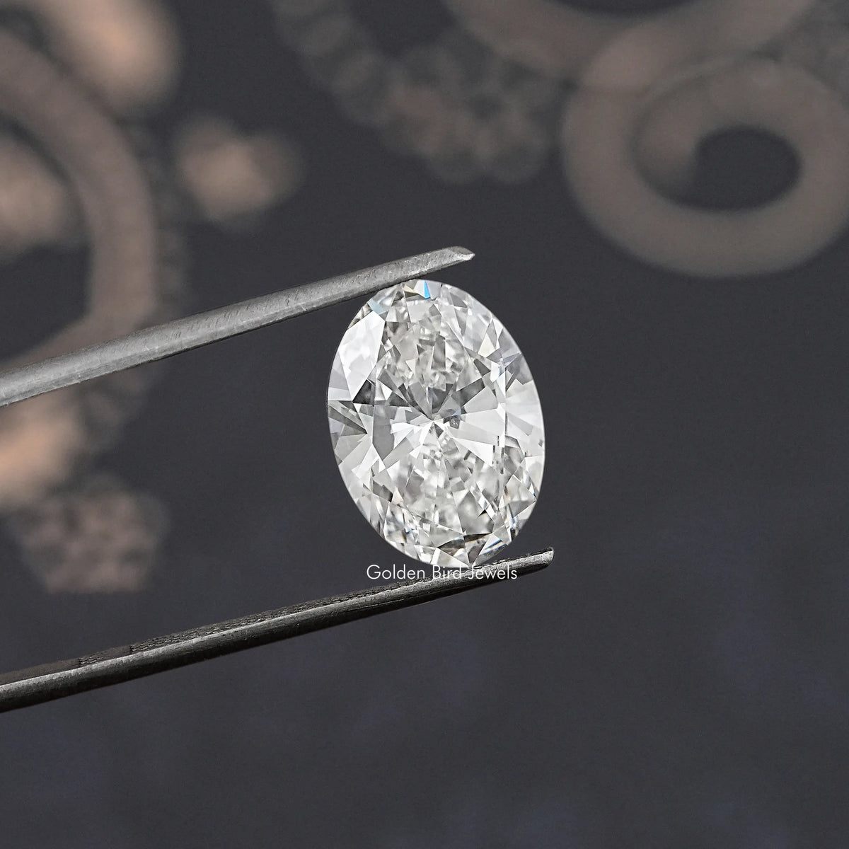Oval-cut lab-grown diamond on tweezers, angled view of faceted surface