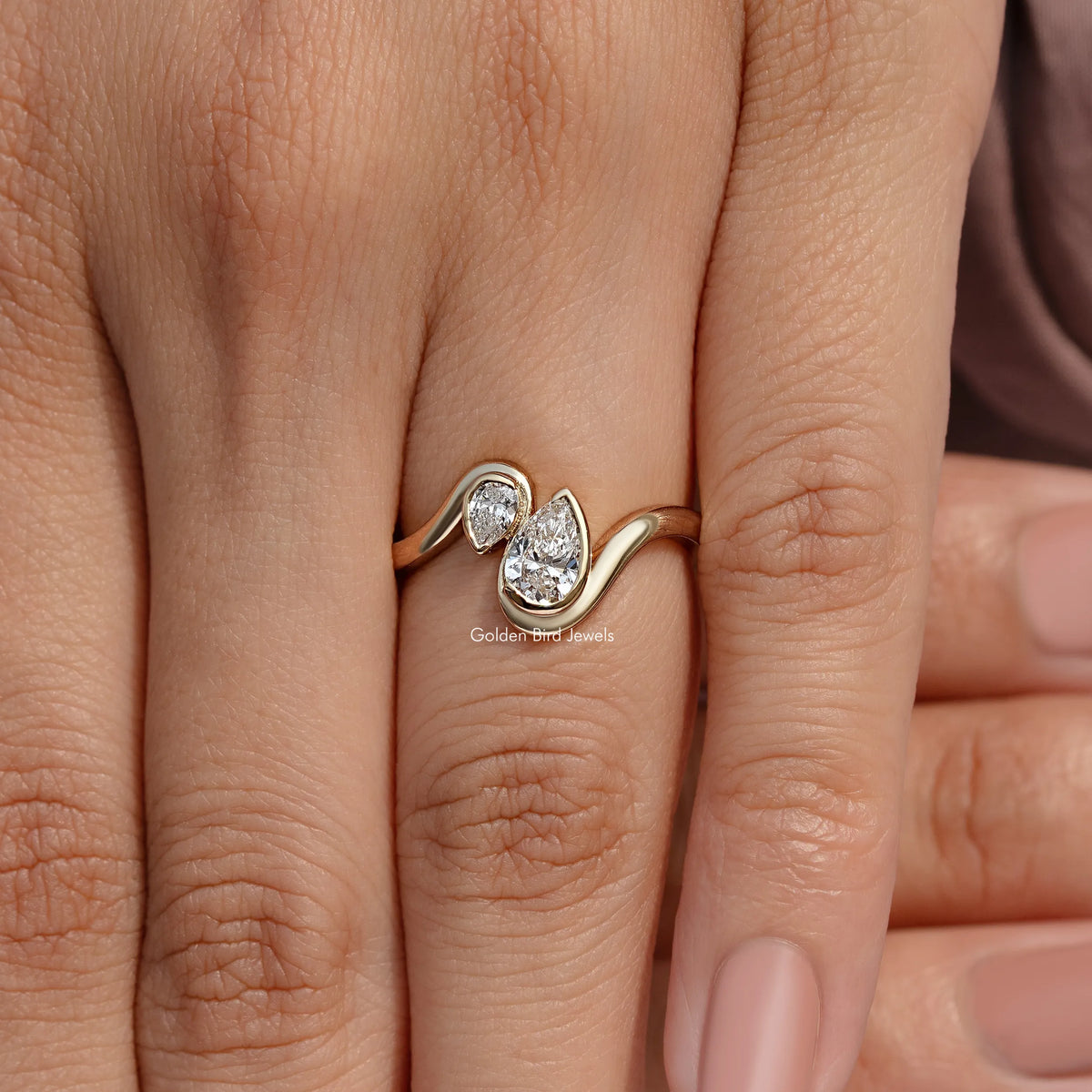 Rose gold toi et moi ring with two pear-cut diamonds, front view on fingers