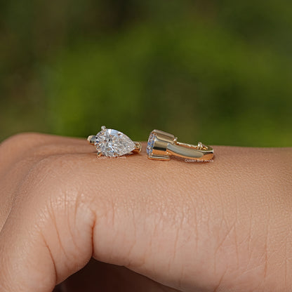 Gold huggie hoop earrings with pear-cut lab diamonds, side view
