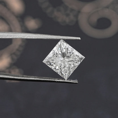 Single princess-cut lab-grown diamond held between metal tweezers