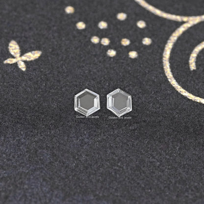 Loose hexagon lab-grown diamond pair, two clear faceted stones front view