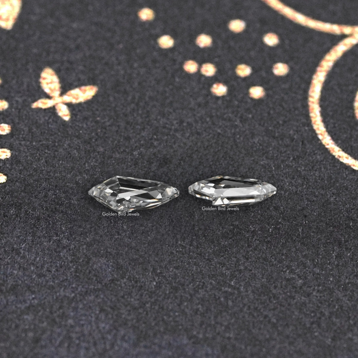 Pair of step-cut lab-grown diamonds, clear rectangular facets.