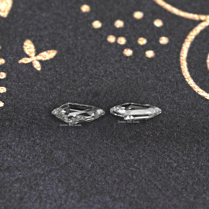 Pair of step-cut lab-grown diamonds, clear rectangular facets.