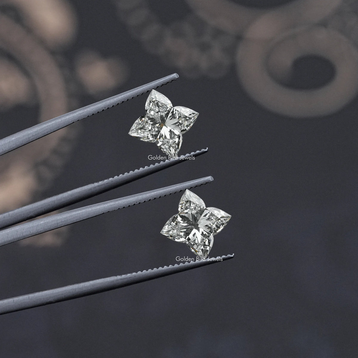 Flower-cut lab-grown diamond stud pair on tweezers, clear square stones