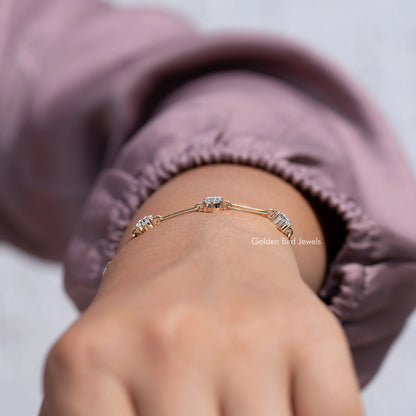 Gold-tone moissanite link bracelet with round-cut stones, arched on wrist