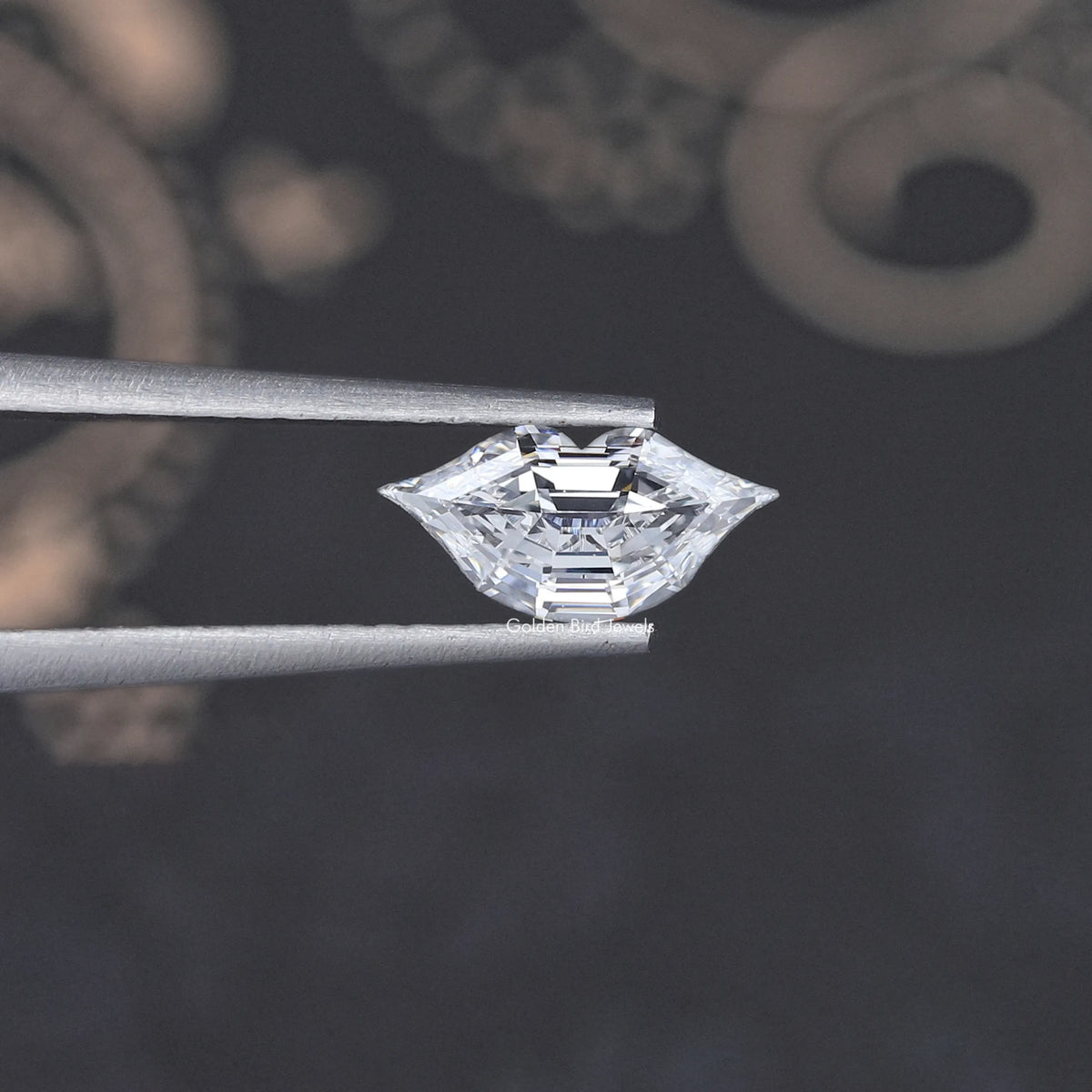 Marquise-cut lab-grown diamond close-up, held between metal tweezers