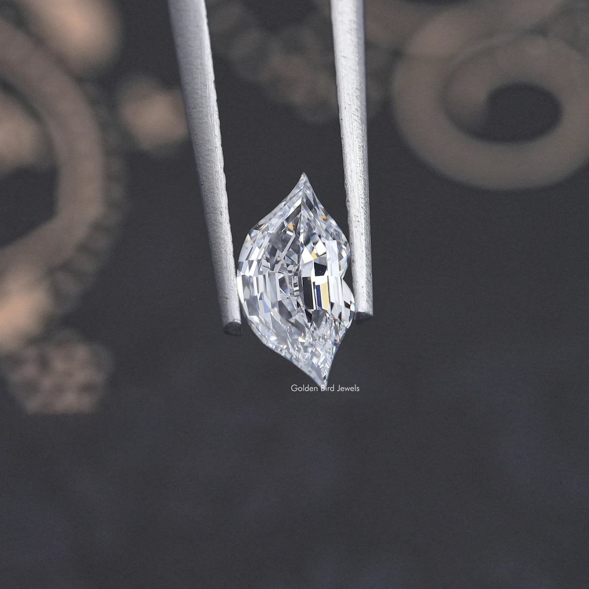 Marquise-cut lab-grown diamond side view, faceted stone held in grips