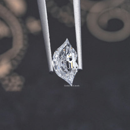 Marquise-cut lab-grown diamond side view, faceted stone held in grips