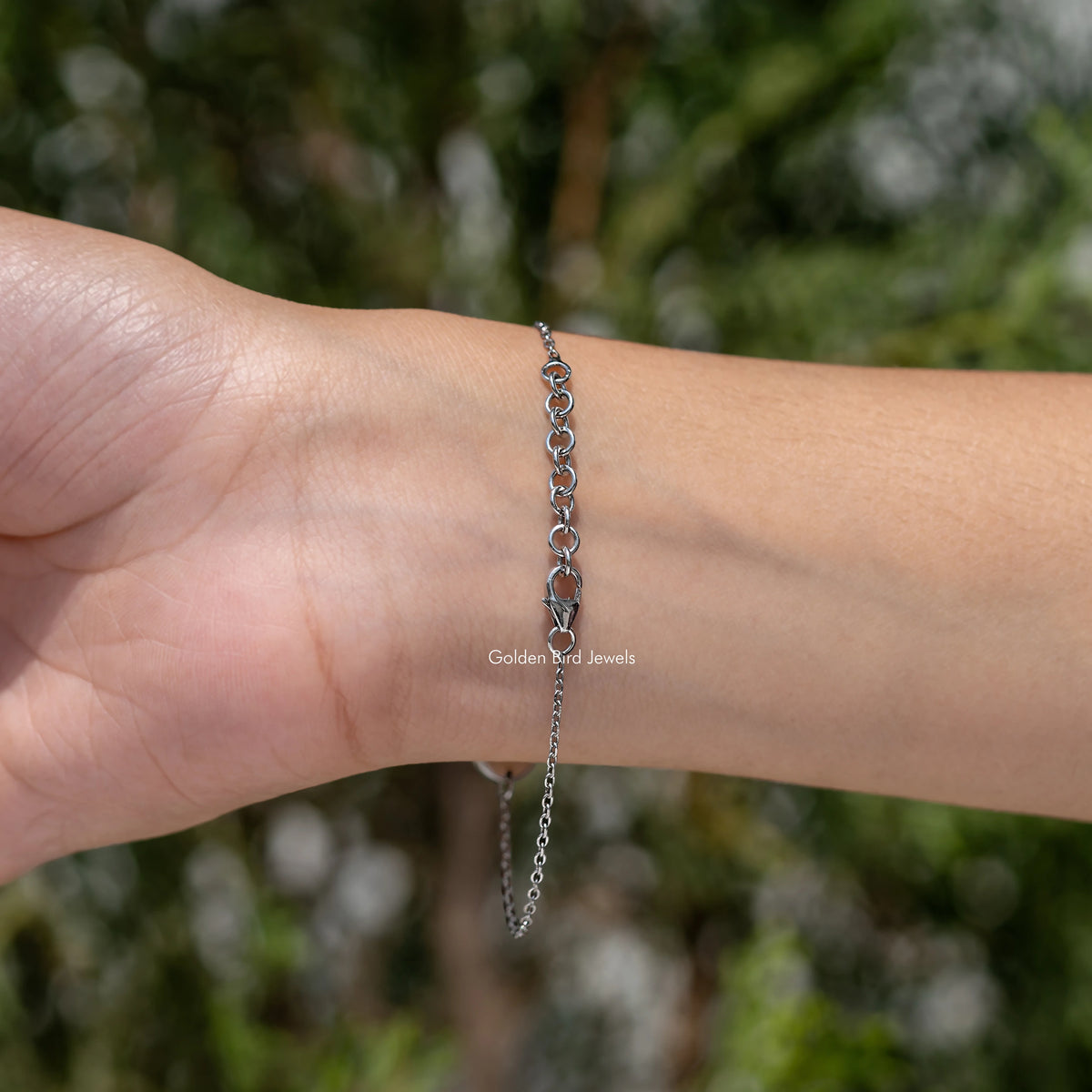 Sterling silver bracelet with round light blue initial A charm and dark blue gemstone
