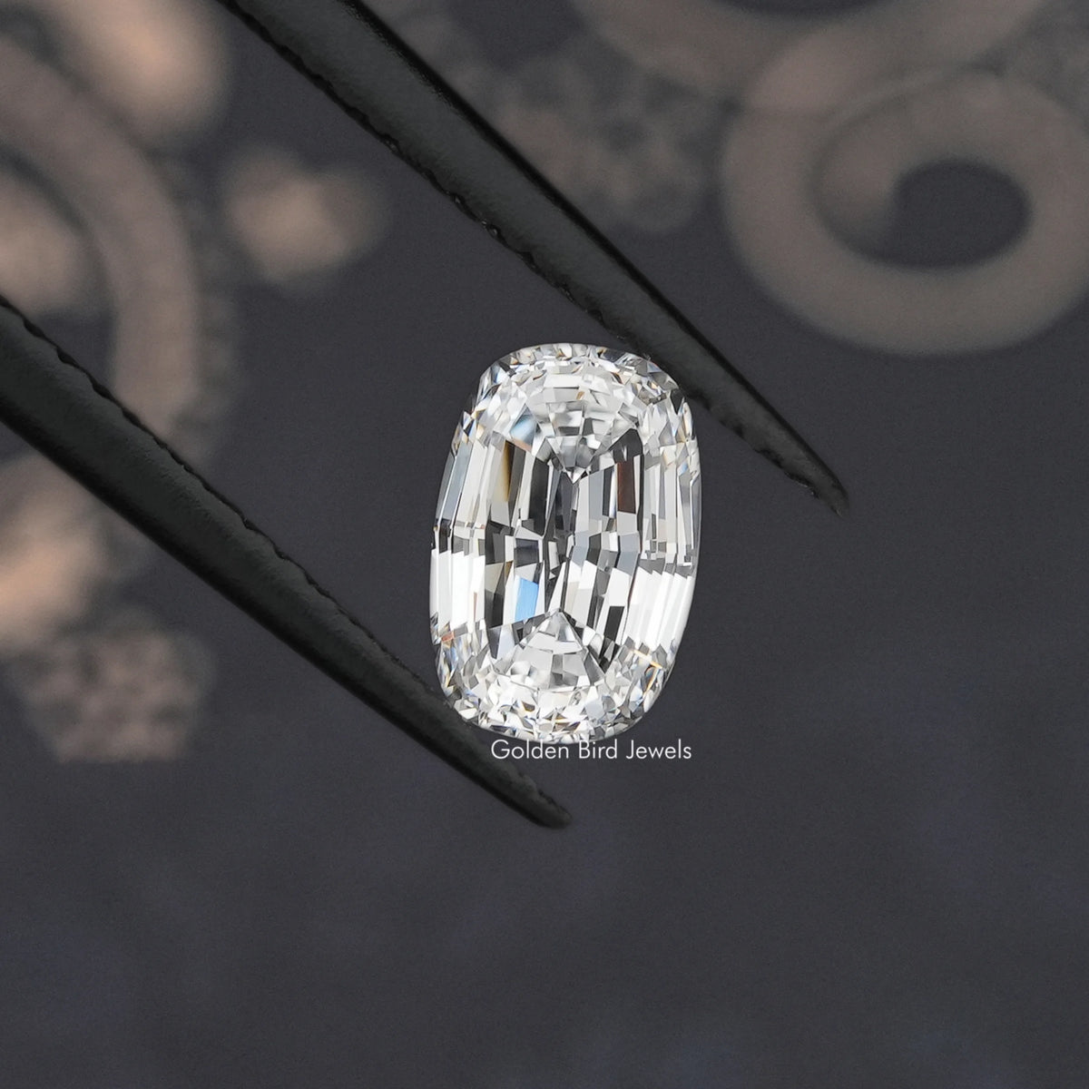 Loose cushion step-cut lab diamond, angled close-up showing detailed facets