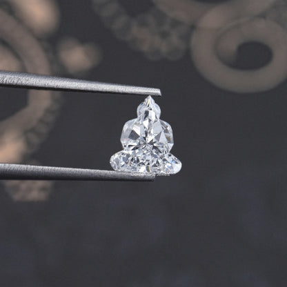 Lab-grown diamond on metal prongs, triangular cluster cut seen from the side