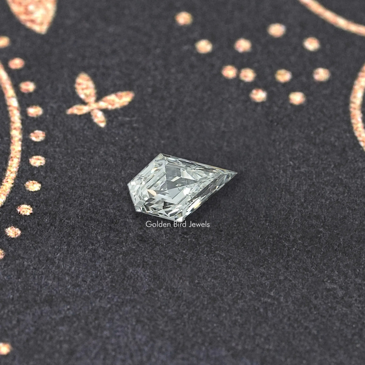 Clear arrow-shaped lab-grown diamond, angled view showing bright facet pattern