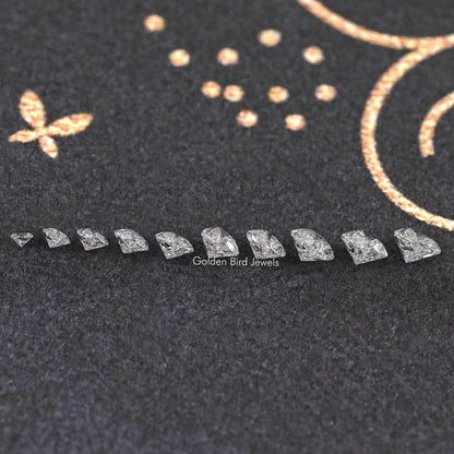 Row of small heart-shaped lab diamonds, faceted sparkle in a line