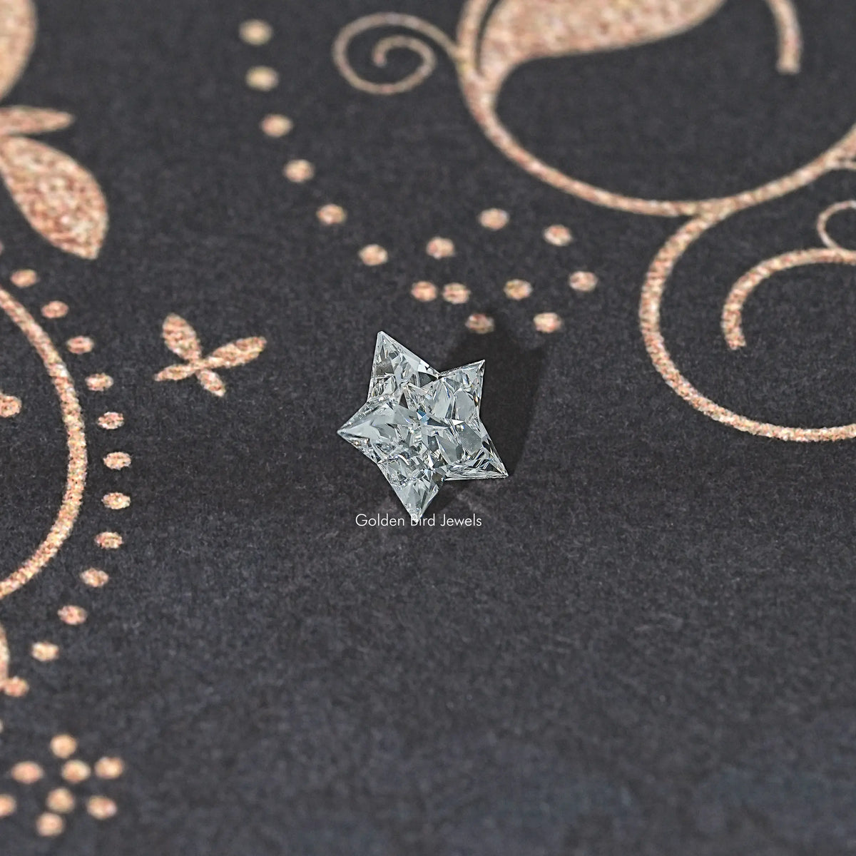 Star-cut lab diamond, clear faceted gem on dark fabric surface