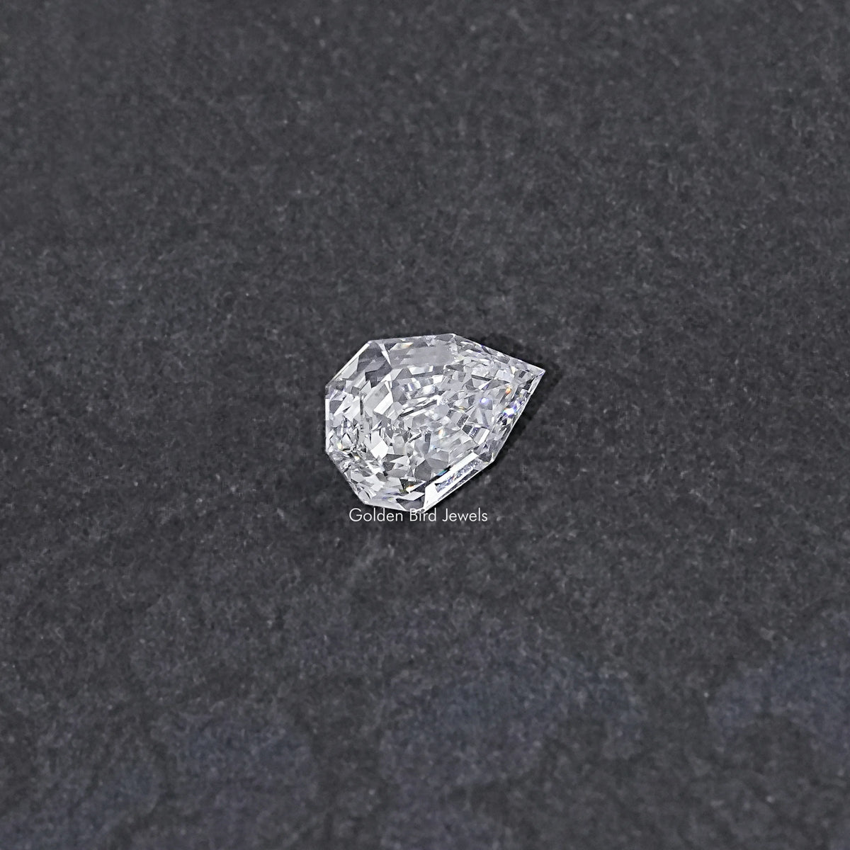 Lab-grown pear-cut diamond, step-cut faceted surface, loose stone view