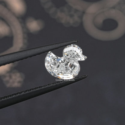 Duck-cut lab-grown diamond with rounded facets, pointed ends, side view