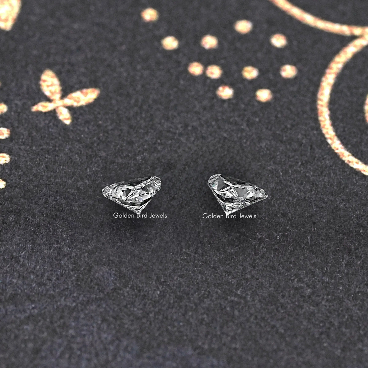Loose trillion-cut lab-grown diamond pair, two clear triangular gemstones on display