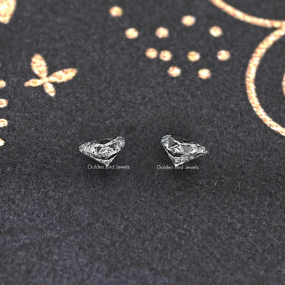 Loose trillion-cut lab-grown diamond pair, two clear triangular gemstones on display