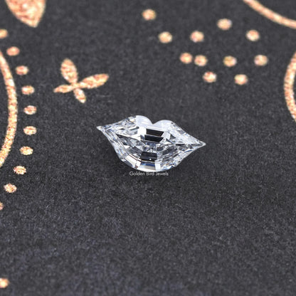 Marquise-cut lab-grown diamond on textured surface, crisp detailed facets
