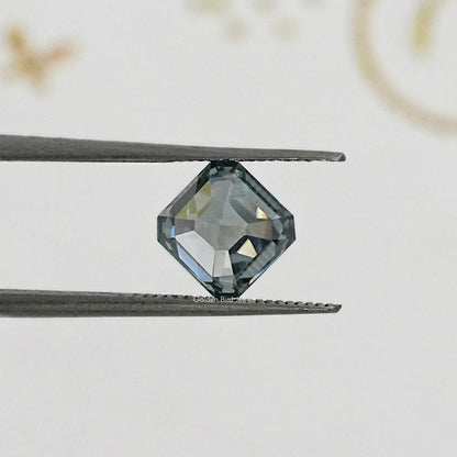 Gray Asscher-cut moissanite gemstone on tweezers, side angle close-up