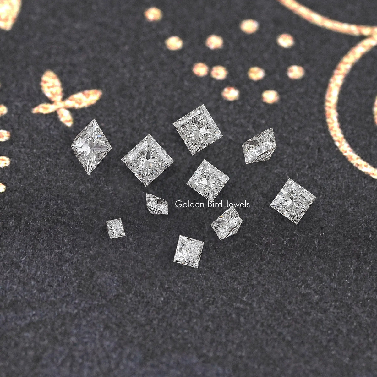 Princess-cut lab-grown diamonds, scattered loose on dark felt