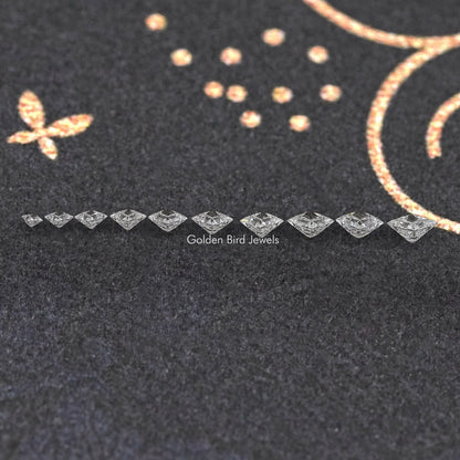 Line of princess-cut lab-grown diamonds, loose and sparkling on dark felt