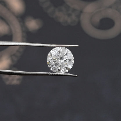 Round lab-grown diamond with silver prongs, close-up