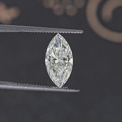 Pear-shaped moissanite loose stone held in tweezers, clear facets