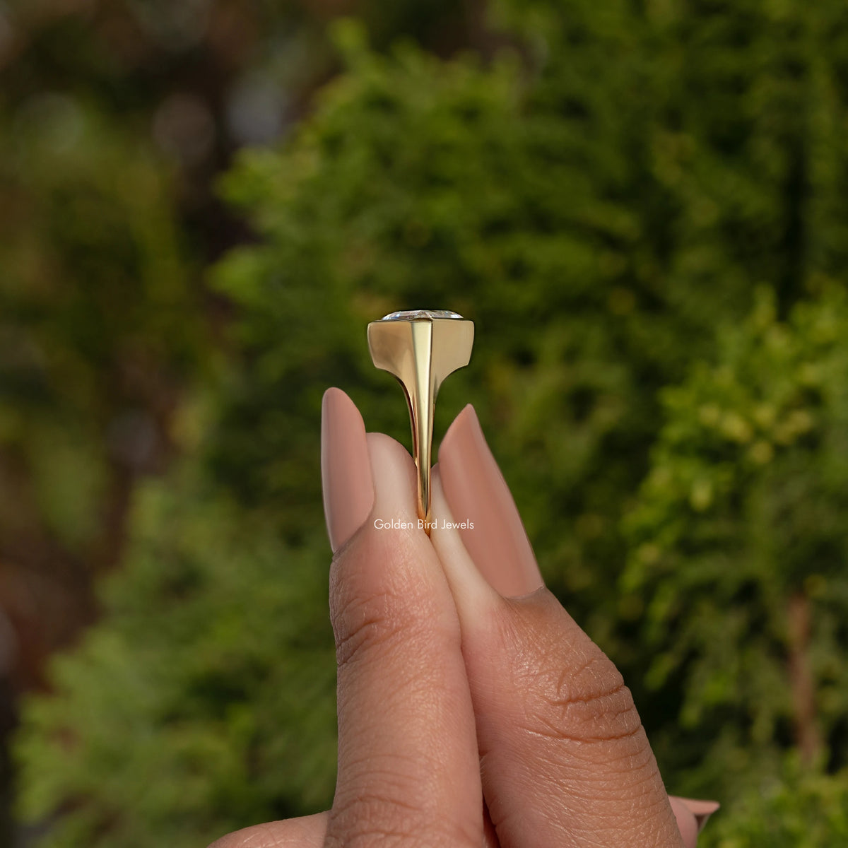 Sterling silver solitaire ring with tall gold bezel mount and lozenge center