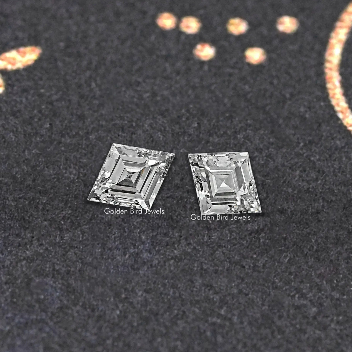 Pair of lozenge-cut lab-grown diamonds, clear stones with faceted edges.