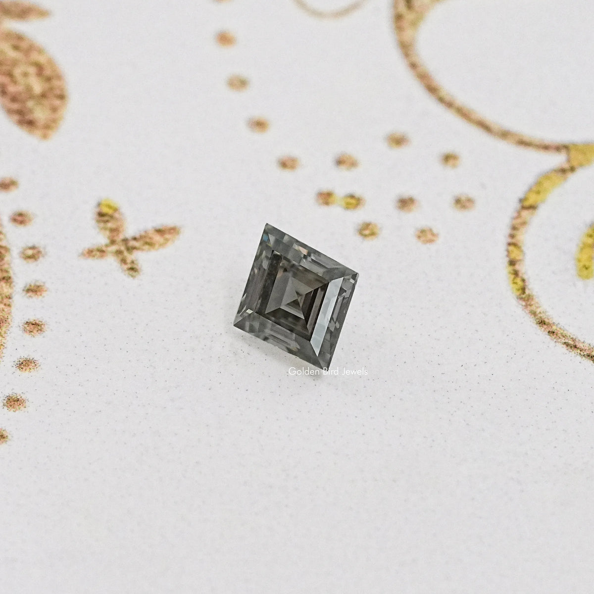 Gray lozenge-cut moissanite gemstone, front view.