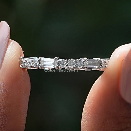 Silver eternity band with alternating baguette and round moissanite stones in prongs