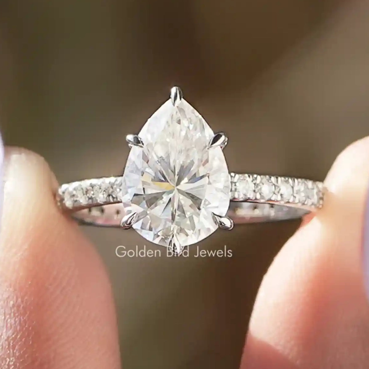 Pear-cut moissanite ring with pavé band