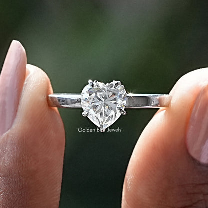 Sterling silver ring with round moissanite center and heart-cut halo detail