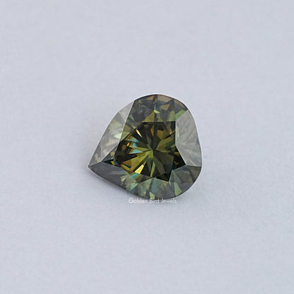Pear-cut moissanite loose stone with dark green and gold facet reflections
