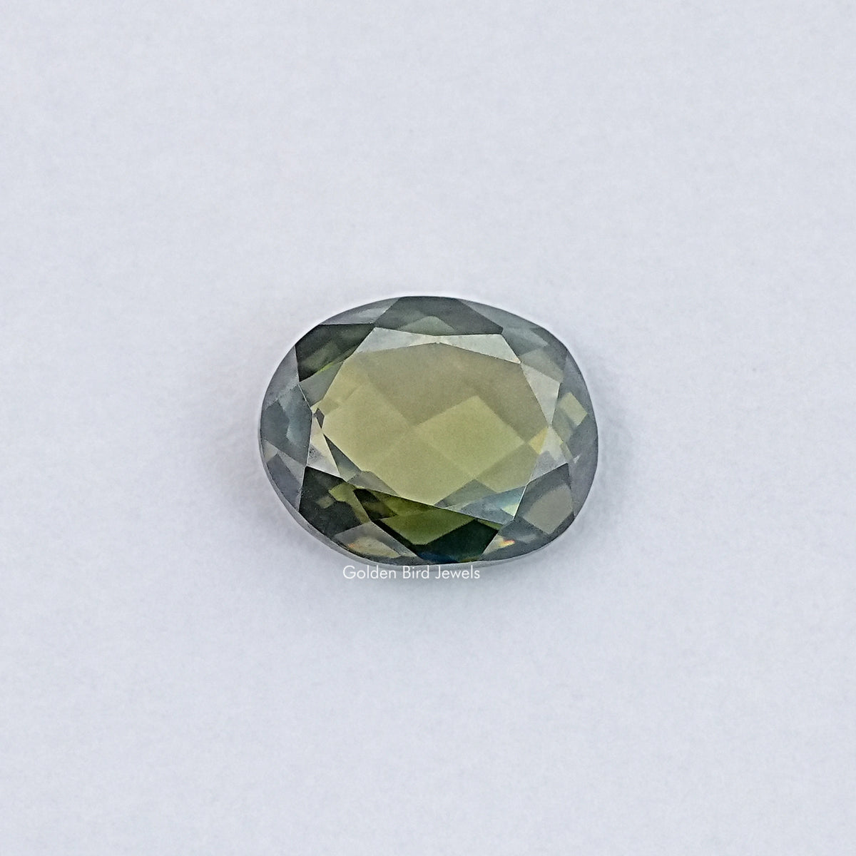 Oval rose-cut loose gemstone, light yellow-green with faceted sparkle