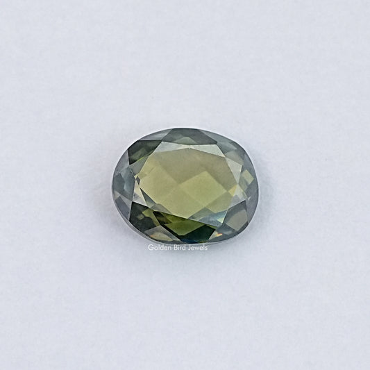 Oval rose-cut loose gemstone, light yellow-green with faceted sparkle