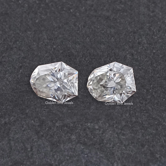 Shield-cut moissanite gemstones pair, clear faceted stones with matching shape