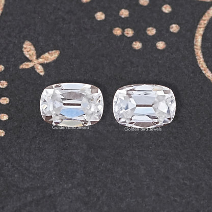 Two rectangular cushion-cut colorless moissanite stones, detailed facets