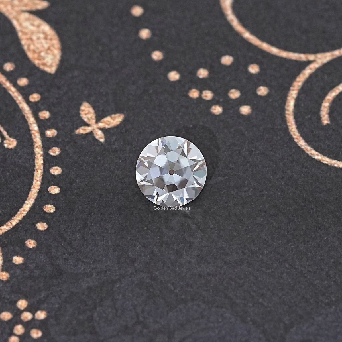 Small round faceted moissanite gemstone, clear with reflective facets