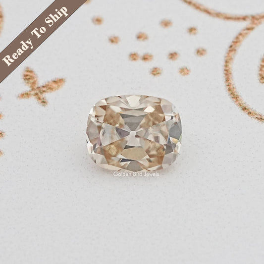 Cushion-cut moissanite gemstone with faceted sparkle, loose yellow tone