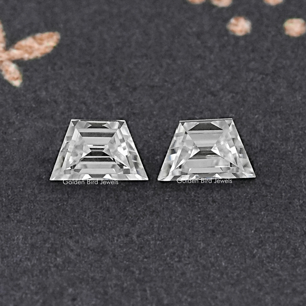 Matching pair of step-cut trapezoid moissanite gemstones, clear faceted stones