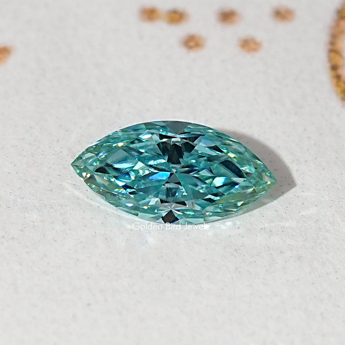 Blue-green marquise-cut moissanite gemstone close-up, faceted