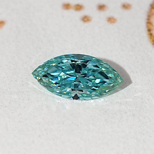 Blue-green marquise-cut moissanite gemstone close-up, faceted