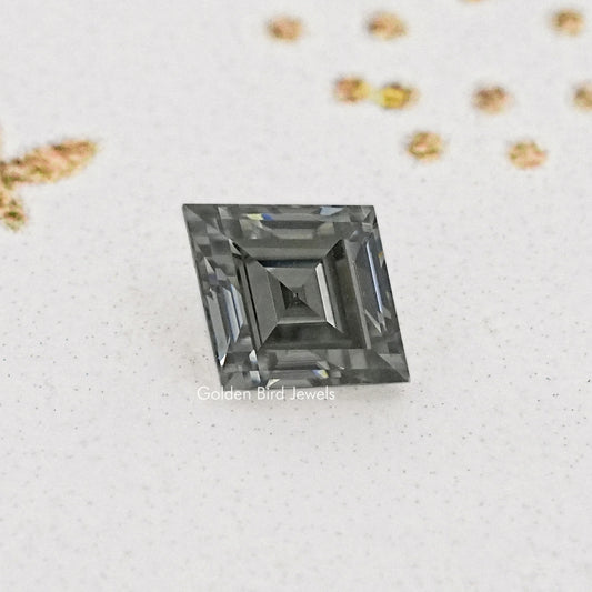 Gray lozenge-cut moissanite with deep step facets, close-up.