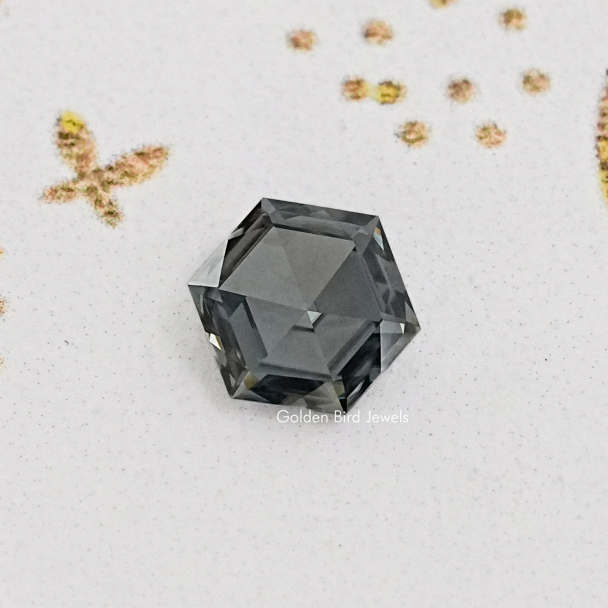 Loose gray hexagon-cut moissanite gemstone, dark gray faceted top view