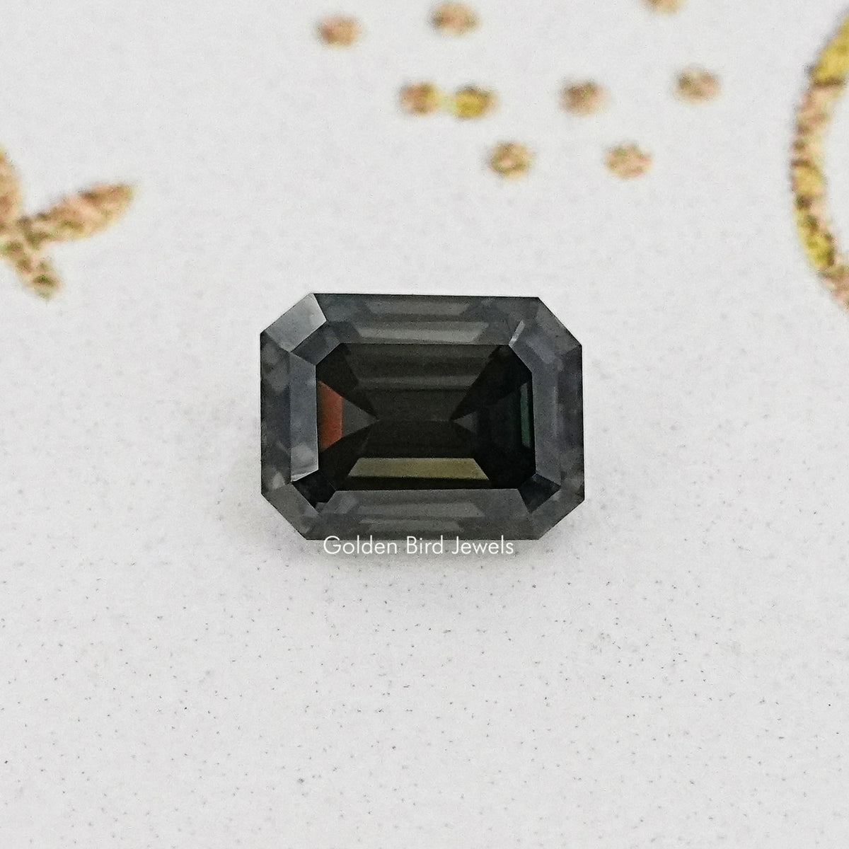 Loose dark gray emerald-cut moissanite gemstone with open pavilion