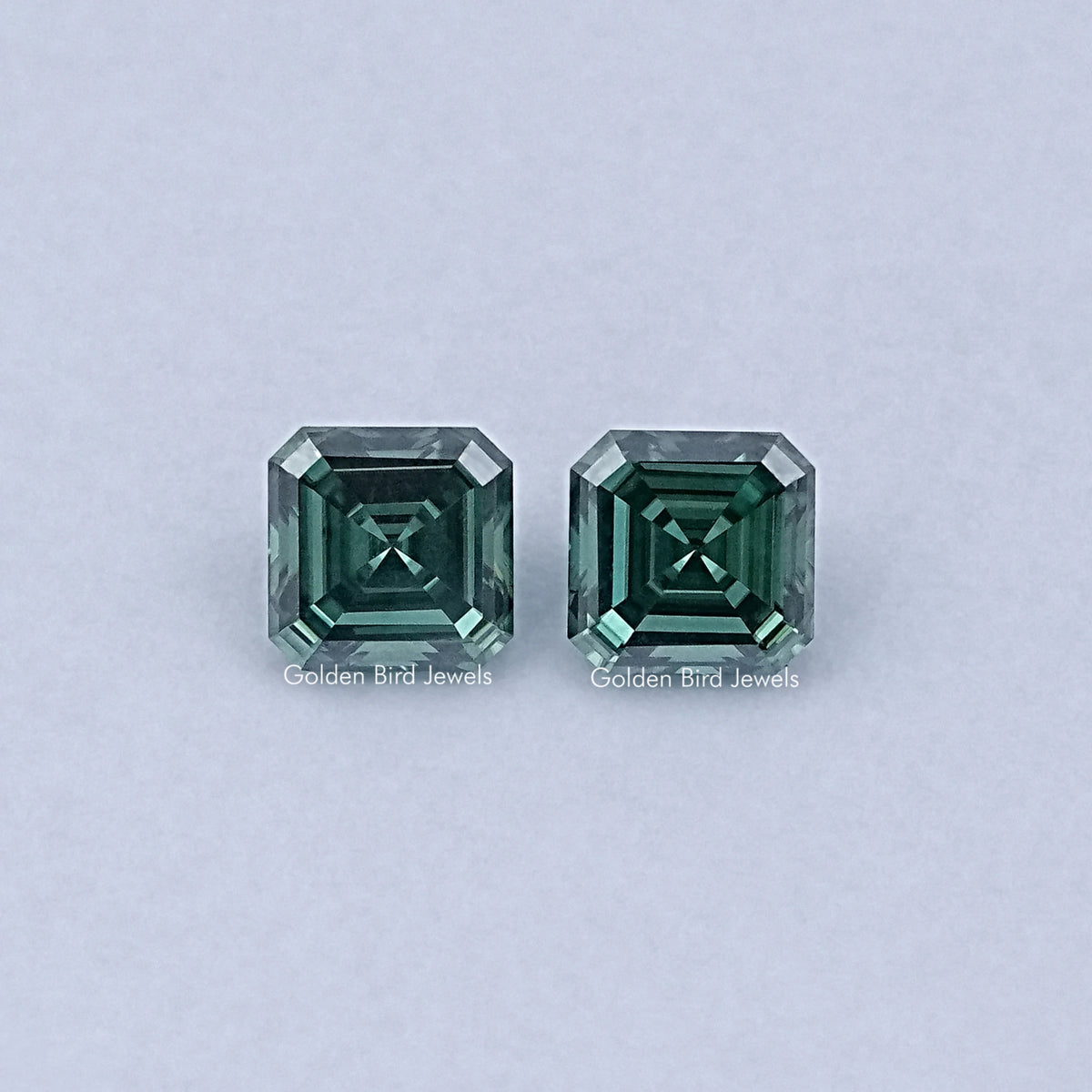 Pair of green Asscher-cut moissanite gemstones, faceted square step cut